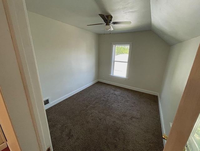 415 Francis St, Faribault, MN 55021 - additional living space featuring dark colored carpet, lofted ceiling, baseboards, and ceiling fan