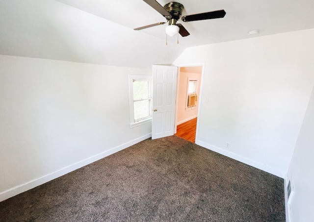 415 Francis St, Faribault, MN 55021 - unfurnished bedroom featuring carpet, vaulted ceiling, baseboards, and a ceiling fan