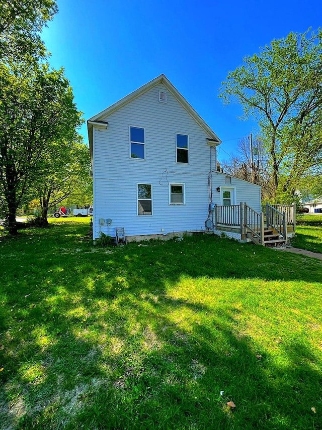 415 Francis St, Faribault, MN 55021 - back of property featuring a lawn and a deck