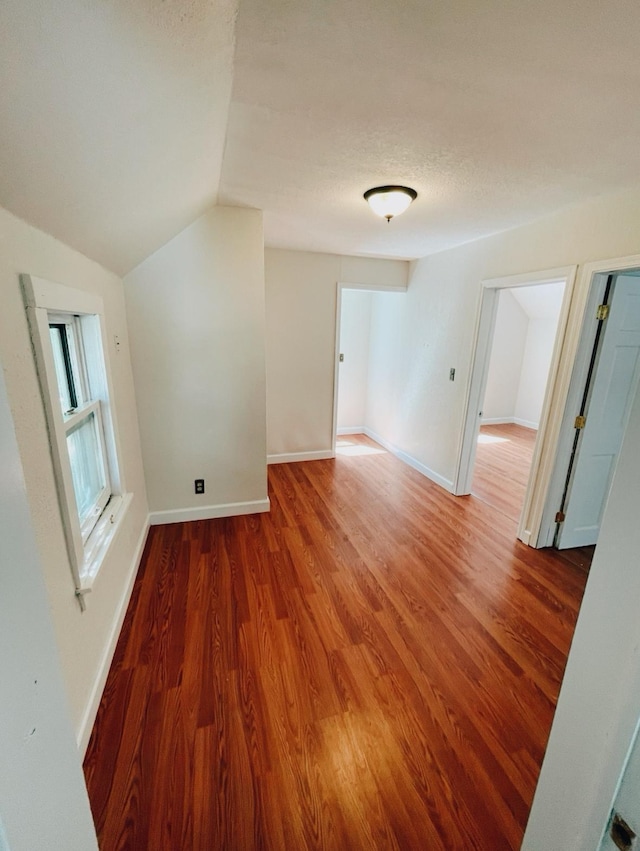 415 Francis St, Faribault, MN 55021 - spare room with wood finished floors, lofted ceiling, and baseboards
