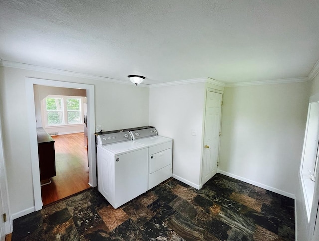 415 Francis St, Faribault, MN 55021 - washroom featuring independent washer and dryer, crown molding, dark stone finish flooring, and baseboards