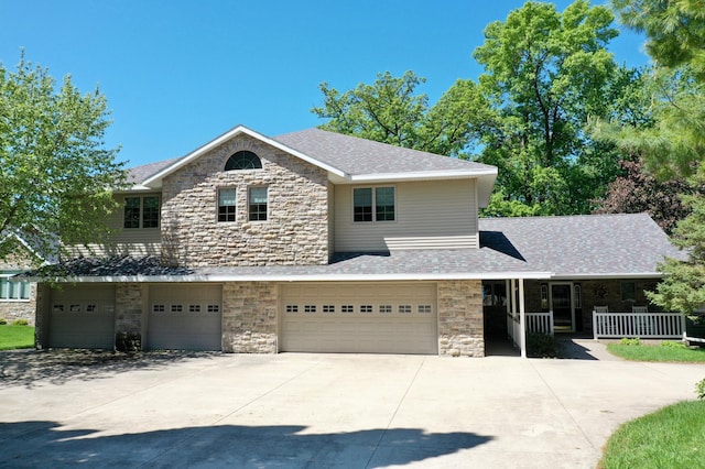 5386 165th St NE, Atwater, MN 56209 - view of front of home featuring stone siding, concrete driveway, and an attached garage