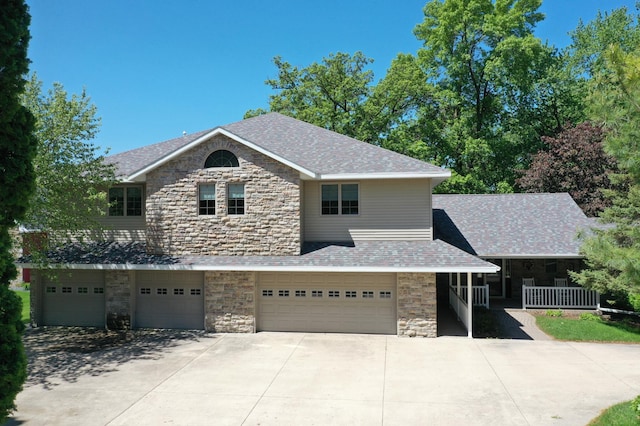 5386 165th St NE, Atwater, MN 56209 - view of front of property with stone siding, driveway, an attached garage, and a porch