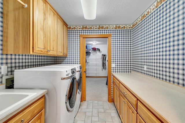 5386 165th St NE, Atwater, MN 56209 - laundry area featuring wallpapered walls, washing machine and dryer, cabinet space, and a textured ceiling
