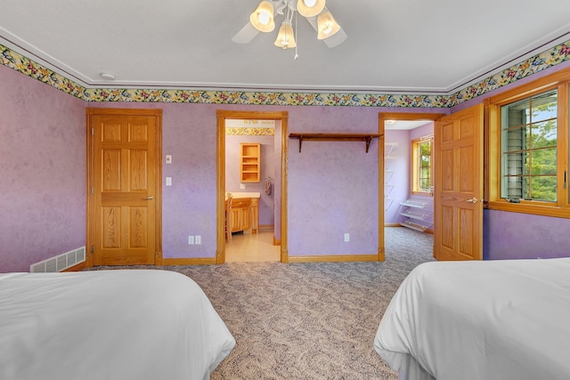 5386 165th St NE, Atwater, MN 56209 - bedroom with carpet flooring, baseboards, ornamental molding, ensuite bath, and ceiling fan
