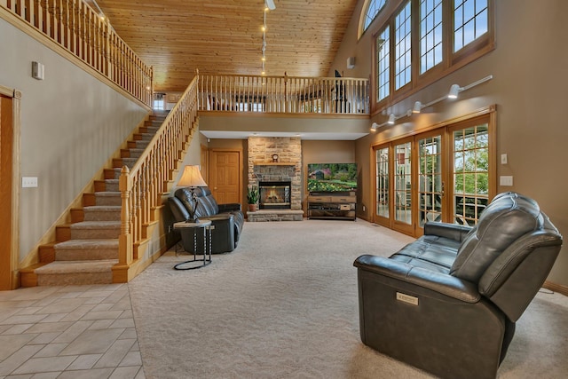 5386 165th St NE, Atwater, MN 56209 - living room featuring a towering ceiling, stairs, wooden ceiling, a stone fireplace, and french doors