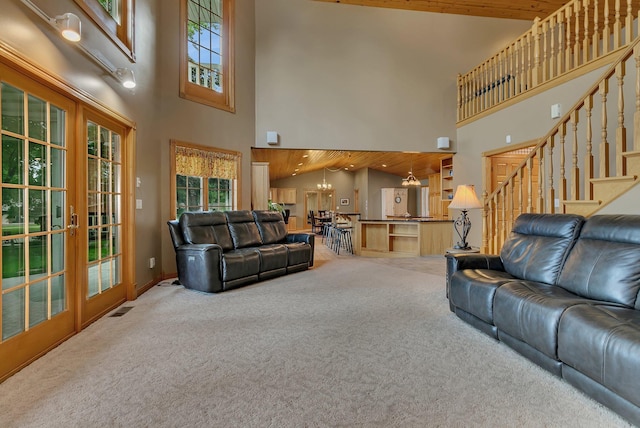 5386 165th St NE, Atwater, MN 56209 - living room with carpet floors, a towering ceiling, french doors, and stairs