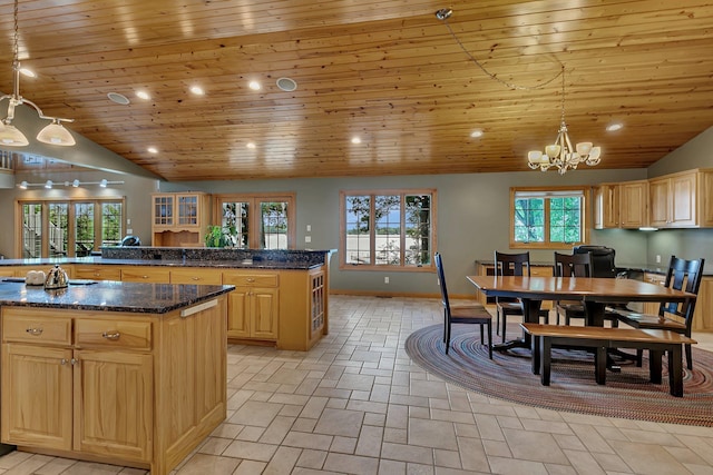 5386 165th St NE, Atwater, MN 56209 - kitchen with a kitchen island, light brown cabinets, a chandelier, lofted ceiling, and baseboards