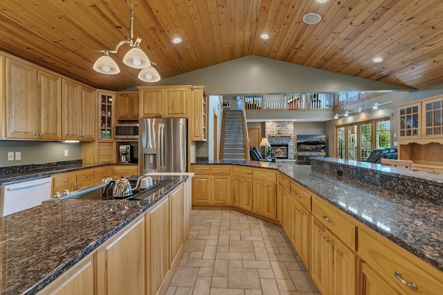 5386 165th St NE, Atwater, MN 56209 - kitchen featuring appliances with stainless steel finishes, lofted ceiling, a large fireplace, recessed lighting, and glass insert cabinets