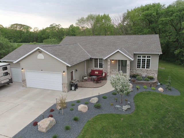201 Ridge Dr, Kenyon, MN 55946 - ranch-style house with an outdoor hangout area, an attached garage, a front yard, a shingled roof, and concrete driveway