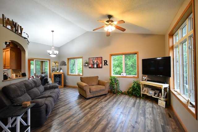 201 Ridge Dr, Kenyon, MN 55946 - living room with dark wood finished floors, vaulted ceiling, a ceiling fan, baseboards, and a chandelier