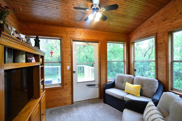 201 Ridge Dr, Kenyon, MN 55946 - living room with healthy amount of natural light, carpet flooring, vaulted ceiling, ceiling fan, and wooden walls