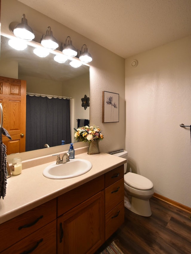 201 Ridge Dr, Kenyon, MN 55946 - full bathroom with wood finished floors, vanity, toilet, baseboards, and curtained shower