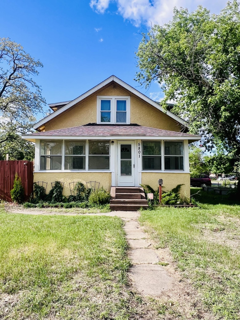 5801 Colfax Ave N, Brooklyn Center, MN 55430 - bungalow-style home with stucco siding and entry steps