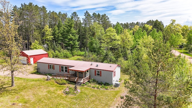 3146 Green Bay Rd, Sturgeon Lake, MN 55783 - back of house featuring a wooden deck, metal roof, cooling unit, a yard, and an outdoor structure