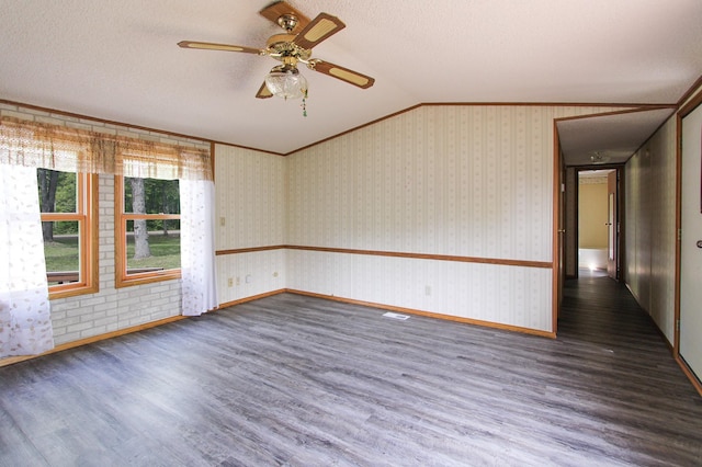 3146 Green Bay Rd, Sturgeon Lake, MN 55783 - spare room featuring vaulted ceiling, wood finished floors, baseboards, a ceiling fan, and crown molding