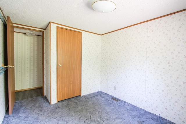 3146 Green Bay Rd, Sturgeon Lake, MN 55783 - unfurnished bedroom with crown molding, carpet flooring, and a textured ceiling