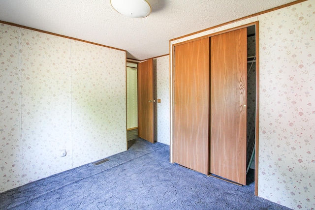 3146 Green Bay Rd, Sturgeon Lake, MN 55783 - unfurnished bedroom featuring crown molding, carpet floors, and a textured ceiling
