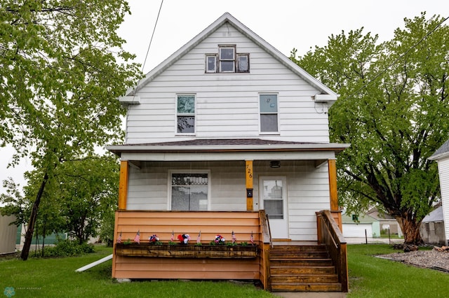 726 College St N, Fargo, ND 58102 - back of house with a porch and a lawn