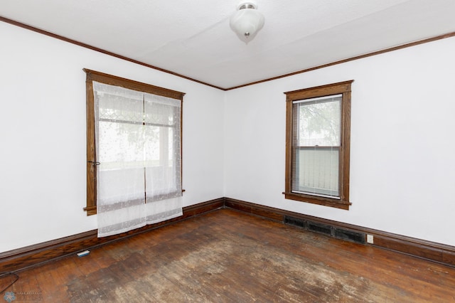 726 College St N, Fargo, ND 58102 - unfurnished room with dark wood-type flooring, crown molding, and baseboards