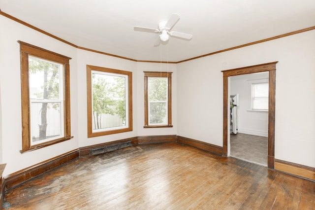726 College St N, Fargo, ND 58102 - empty room featuring hardwood / wood-style floors, baseboards, healthy amount of natural light, and ornamental molding