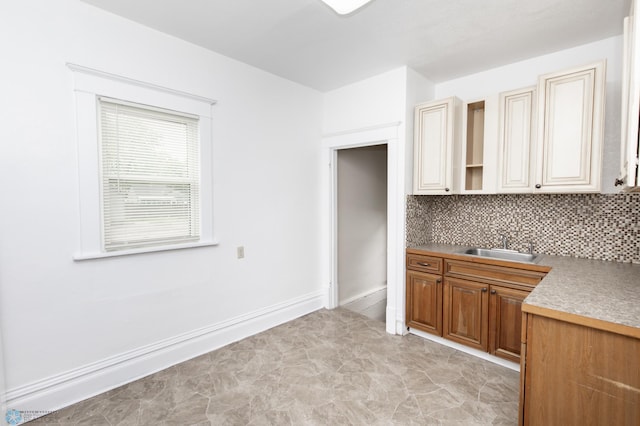 726 College St N, Fargo, ND 58102 - kitchen with a sink, backsplash, open shelves, and baseboards