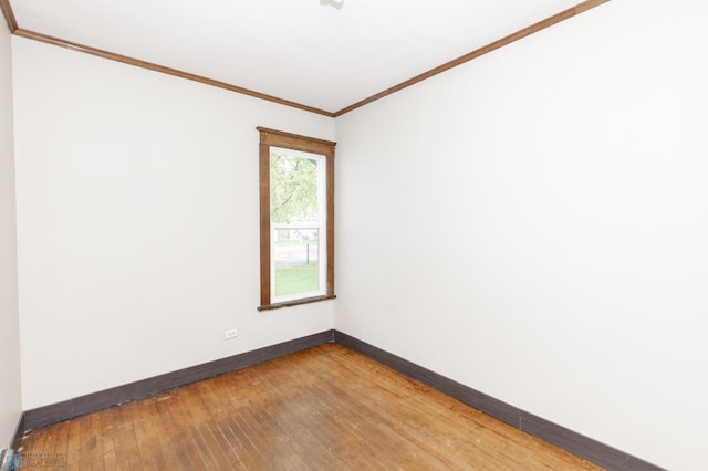 726 College St N, Fargo, ND 58102 - empty room featuring baseboards, crown molding, and hardwood / wood-style flooring