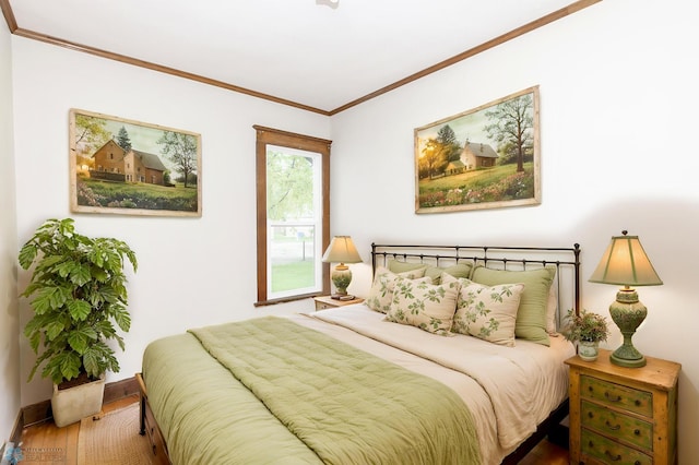 726 College St N, Fargo, ND 58102 - bedroom with wood finished floors, ornamental molding, and baseboards