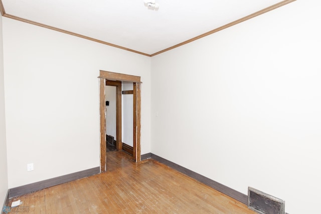 726 College St N, Fargo, ND 58102 - empty room featuring baseboards, light wood-style floors, and crown molding