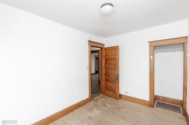 726 College St N, Fargo, ND 58102 - unfurnished bedroom featuring light wood-style floors, baseboards, and a closet