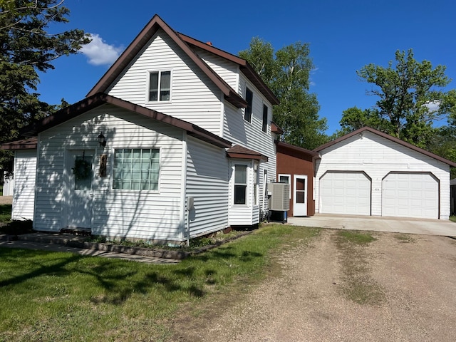 404 1st St S, Hoffman, MN 56339 - view of front of home with a garage, an outbuilding, dirt driveway, and a front lawn