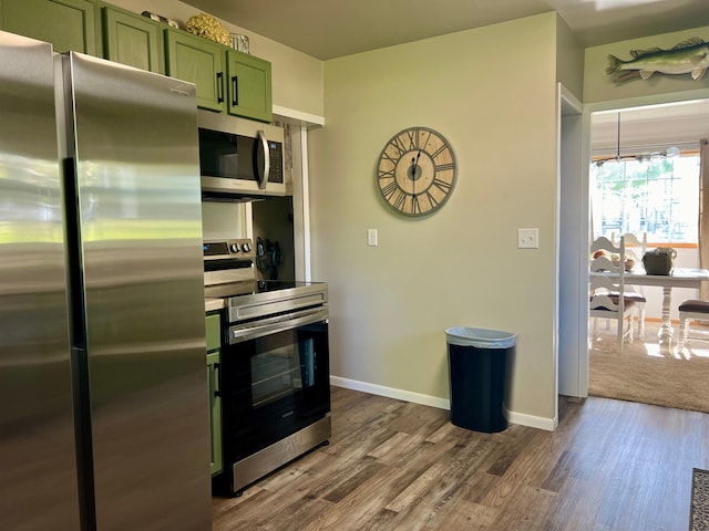 404 1st St S, Hoffman, MN 56339 - kitchen with appliances with stainless steel finishes, green cabinets, dark wood-type flooring, and baseboards