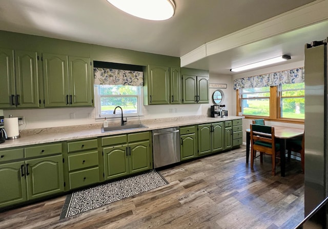 404 1st St S, Hoffman, MN 56339 - kitchen featuring stainless steel appliances, a sink, green cabinets, light countertops, and wood finished floors