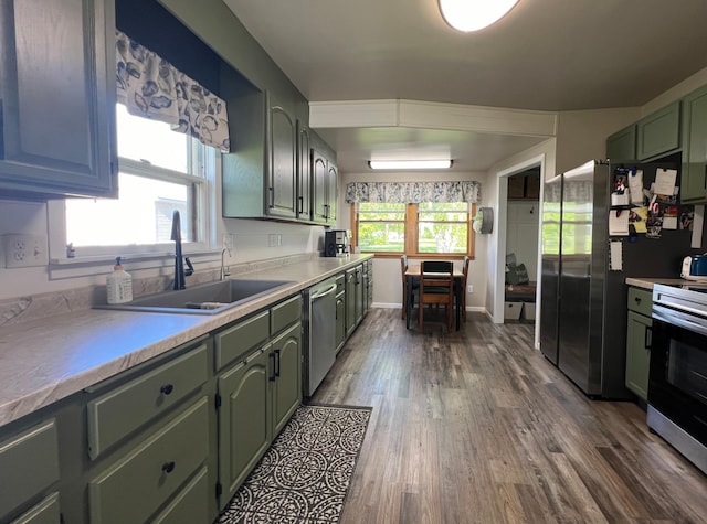 404 1st St S, Hoffman, MN 56339 - kitchen featuring green cabinetry, appliances with stainless steel finishes, a sink, dark wood finished floors, and light countertops