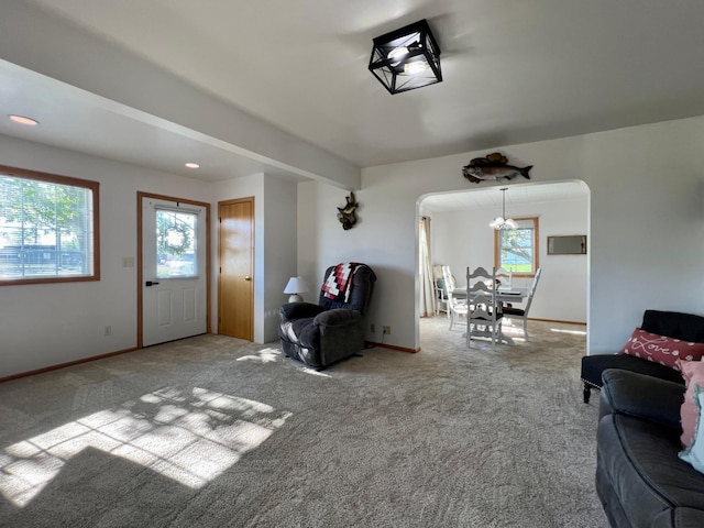404 1st St S, Hoffman, MN 56339 - living room featuring carpet, arched walkways, and baseboards