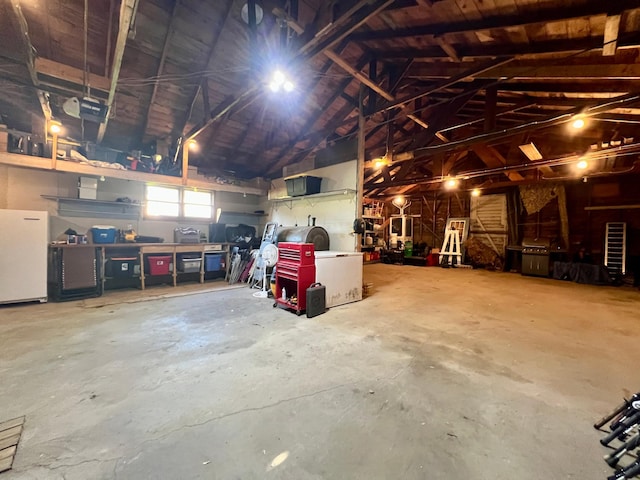 404 1st St S, Hoffman, MN 56339 - garage with fridge, a workshop area, and a garage door opener