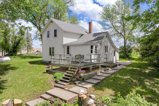 7149 92nd Ave SW, Lemond Twp, MN 56026 - back of house featuring a chimney, roof with shingles, a deck, a lawn, and stairs