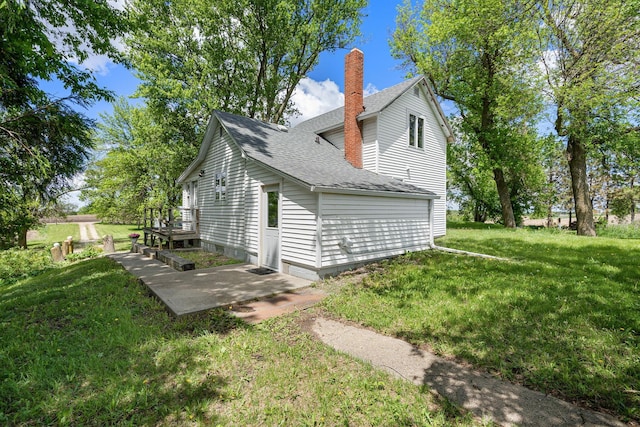 7149 92nd Ave SW, Lemond Twp, MN 56026 - view of side of home with a chimney, roof with shingles, and a yard