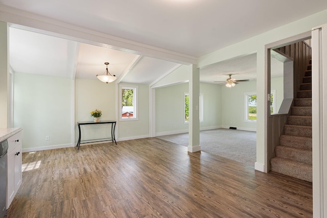 7149 92nd Ave SW, Lemond Twp, MN 56026 - unfurnished living room with healthy amount of natural light, stairs, wood finished floors, and baseboards