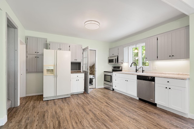 7149 92nd Ave SW, Lemond Twp, MN 56026 - kitchen featuring appliances with stainless steel finishes, dark wood finished floors, baseboards, and light countertops