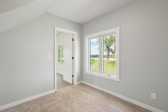 7149 92nd Ave SW, Lemond Twp, MN 56026 - carpeted empty room featuring vaulted ceiling and baseboards