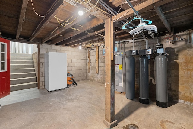 7149 92nd Ave SW, Lemond Twp, MN 56026 - unfinished below grade area with electric water heater, freestanding refrigerator, and stairs