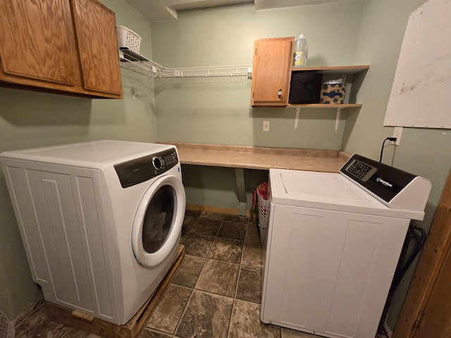 21824 County Highway 20, Lake Eunice Twp, MN 56501 - laundry area featuring washer and dryer, cabinet space, and dark stone finish floors