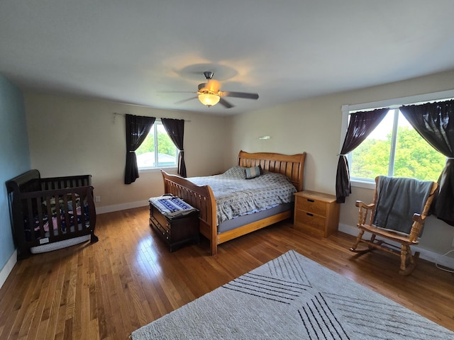 21824 County Highway 20, Lake Eunice Twp, MN 56501 - bedroom with baseboards, wood finished floors, and ceiling fan
