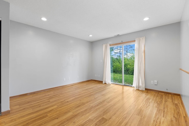 832 Woodgate Dr Unit 107, Vadnais Heights, MN 55127 - unfurnished room with light wood-type flooring, baseboards, and recessed lighting