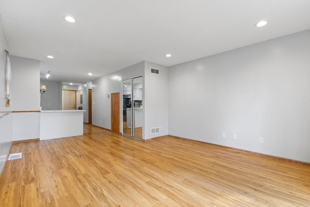 832 Woodgate Dr Unit 107, Vadnais Heights, MN 55127 - unfurnished living room with light wood-style flooring and recessed lighting