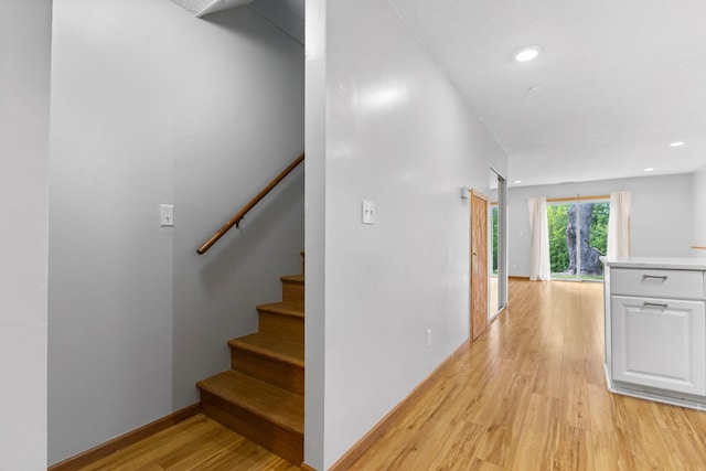 832 Woodgate Dr Unit 107, Vadnais Heights, MN 55127 - hallway featuring light wood-style floors, stairs, recessed lighting, and baseboards