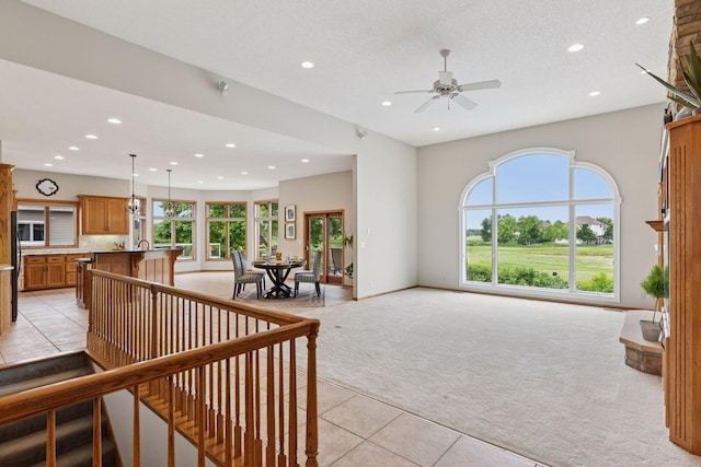 11565 Palisade Ct NE, Blaine, MN 55449 - living area with light carpet, recessed lighting, light tile patterned floors, and a ceiling fan