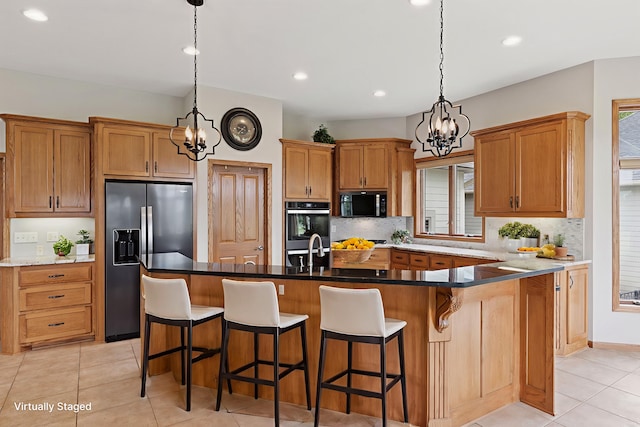 11565 Palisade Ct NE, Blaine, MN 55449 - kitchen with appliances with stainless steel finishes, a chandelier, tasteful backsplash, light tile patterned flooring, and recessed lighting