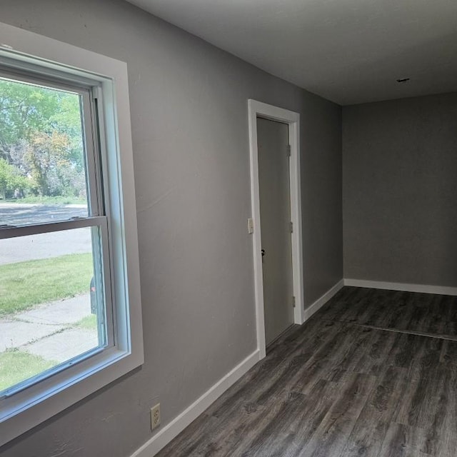 410 9th St, Morris, MN 56267 - unfurnished room with plenty of natural light, dark wood-type flooring, and baseboards